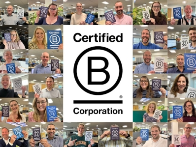 Prime employees with happy faces holding the B Corp logo