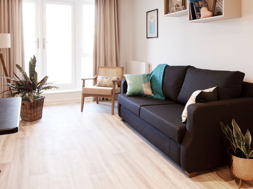 Keyworker accommodation with sofa and table in living room.